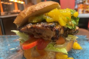 Jerk burger, mango salsa, escovitche veggies, homemade bun