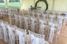 White lace sashes over chiavari chairs