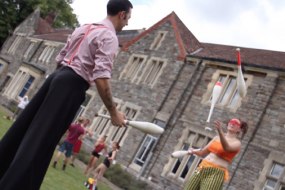 Stilt performers juggling