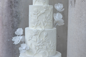 Textured magnolia 4 tier wedding cake featuring abstract roses - Stansted Park