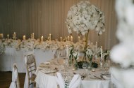 White rose and orchid wedding table centre pieces with top table floral styling