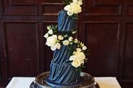 Navy blue and gold draped fondant wedding cake.