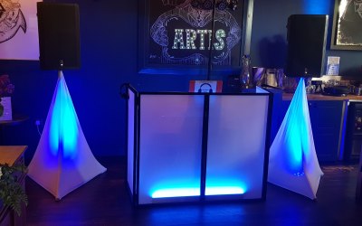 DJ booth and speaker setup with lights