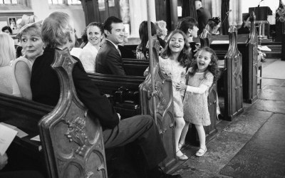 Kids watching bride enter church prior to wedding ceremony