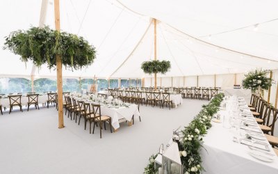 Petal Pole marquee with crossback chairs and light grey carpet