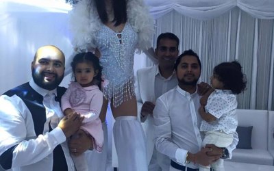 Stilt walkers at a white party in manchester.