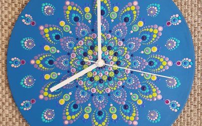 A dot mandala clock on an old record