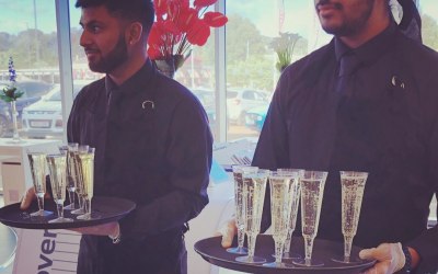 Team members serving Prosecco