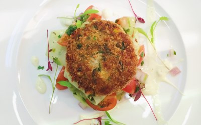 Indian spiced potato and tofu cake with a cherry tomato, cucumber and toasted cumin seed salad with a curried yoghurt