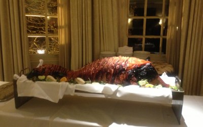 Whole roasted hog displayed on a table as a centre piece