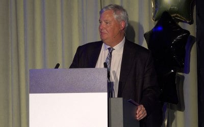 event speaker at lectern with ear mic.jpg