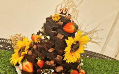 A brownie tower set up in a garden wedding 