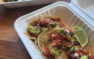 Fire-roasted Veggie Medley tacos (front), and our signature local beef birria tacos with rich savoury broth for dipping. 