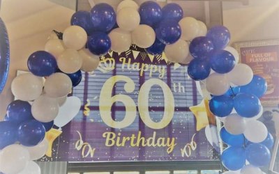 Our 60th backdrop with balloon aches