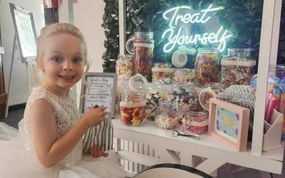 Candy cart including sweets and bags with personalised stickers on 