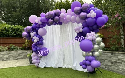 Elegant back drop with organic balloon garland.