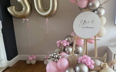 Helium balloons and welcome sign