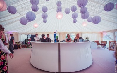 Paper lanterns, linings, round bar in a wedding marquee