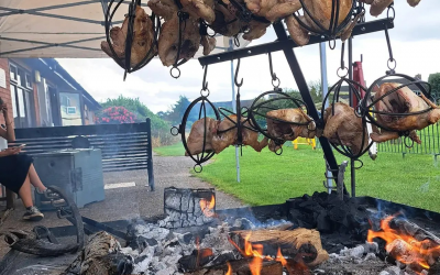 Asado hanging chickens